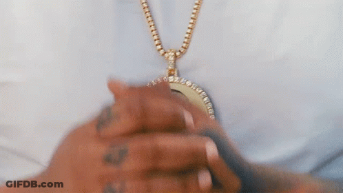 Person Wearing Gold Chain With Pendant GIF