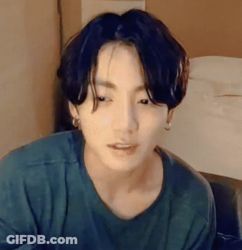 Person Wearing Green Shirt And Earrings GIF