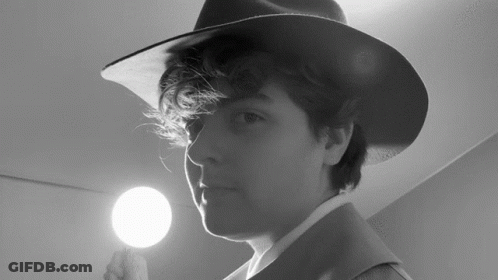 Person Wearing Hat Holding Light GIF