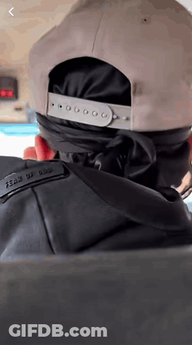Person Wearing Hat With Fear Of God On Back GIF