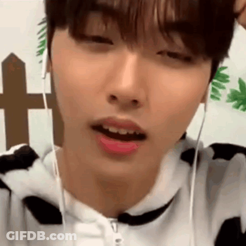 Person Wearing Headphones And Cow Print Sweater GIF
