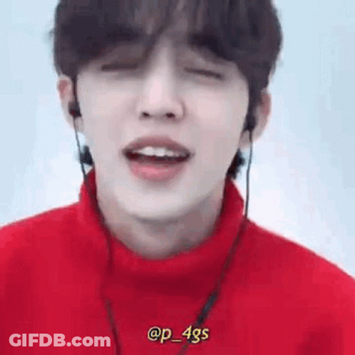 Person Wearing Headphones And Red Turtleneck GIF
