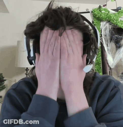 Person Wearing Headphones Covering Face GIF
