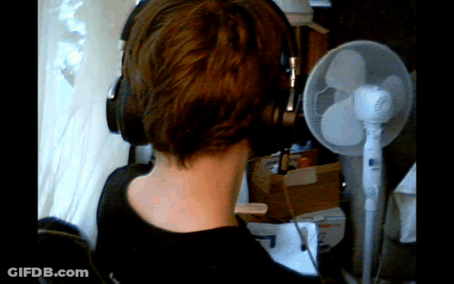 Person Wearing Headphones In Front Of Fan GIF