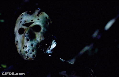 Person Wearing Jason Voorhees Helmet In Dark GIF