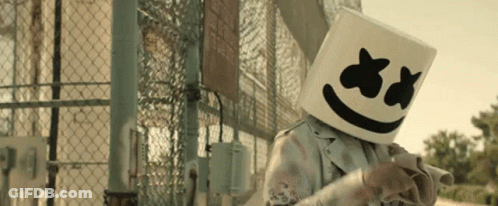 Person Wearing Marshmello Mask In Front Of Chain Link Fence GIF