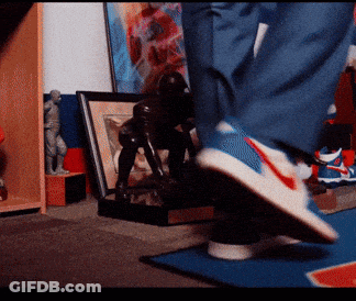 Person Wearing Nike Shoes On Blue Rug GIF