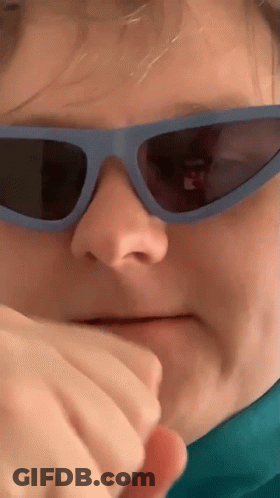 Person Wearing Sunglasses Covering Mouth GIF