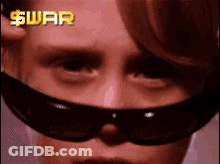 Person Wearing Sunglasses With Dollar Sign GIF
