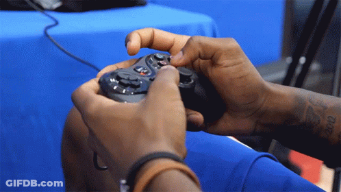 Person With Arm Tattoo Holding Game Controller GIF