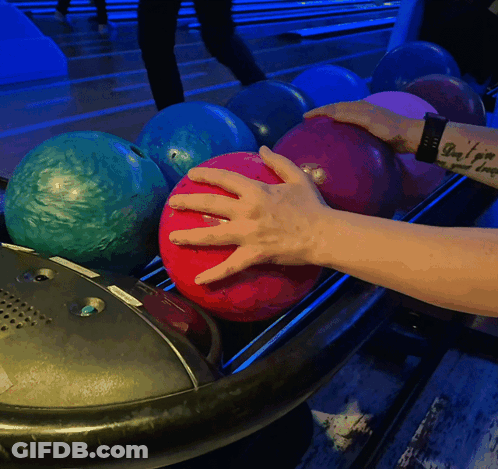 Person With Arm Tattoo Putting Bowling Ball GIF