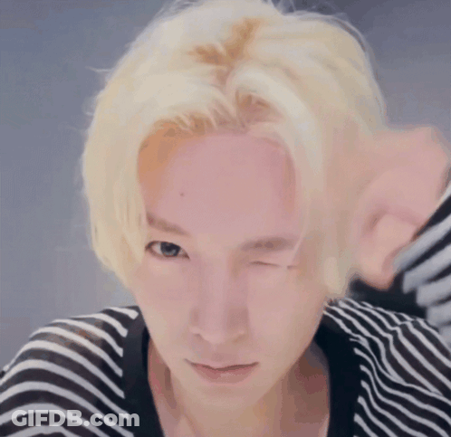 Person With Blonde Hair Winking GIF