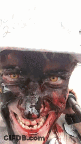 Person With Blood On Face In Helmet Smiling GIF