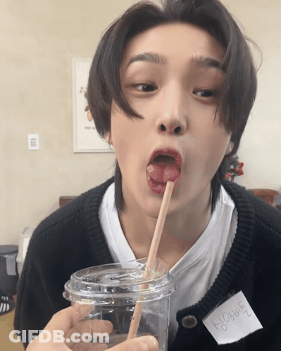 Person With Donghee Name Tag Drinking Straw GIF