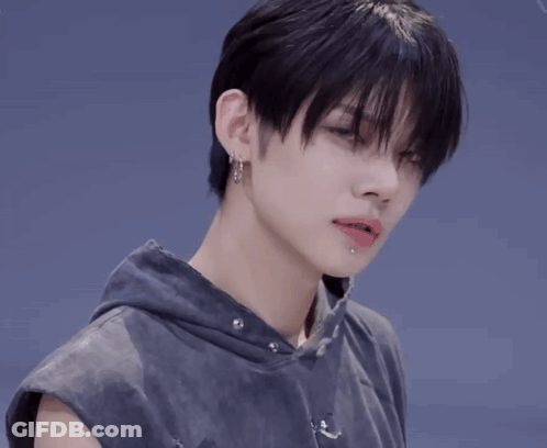 Person With Earrings And Sleeveless Hoodie GIF