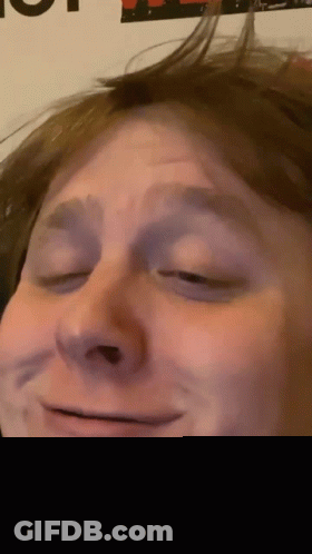 Person With Eyes Closed And Poster Saying A GIF