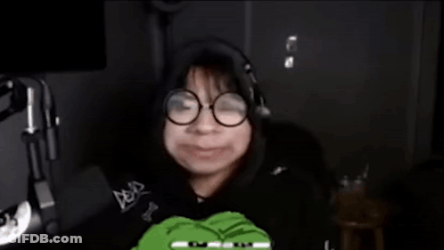 Person With Glasses And Headphones Holding Green Frog GIF