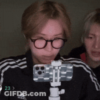 Person With Glasses Holding Phone On Tripod Number 23 GIF
