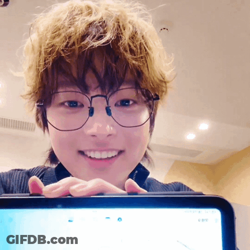 Person With Glasses Smiling At Tablet GIF