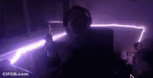 Person With Headphones In Dark Purple Room GIF