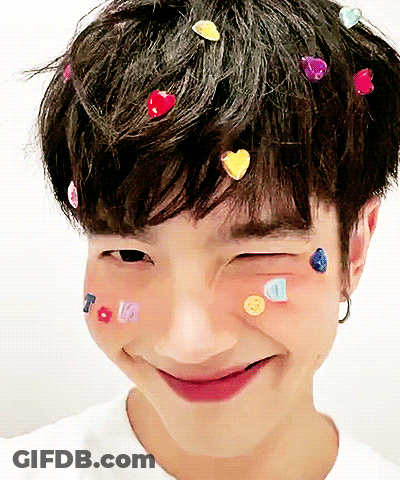 Person With Hearts In Hair And Smiley Faces GIF