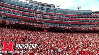 Person With Number 10 Headband In Front Of Red Sign GIF