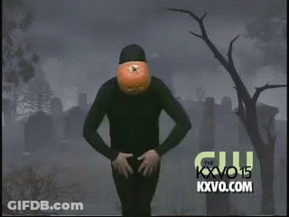 Person With Pumpkin Head Dancing In Cemetery GIF