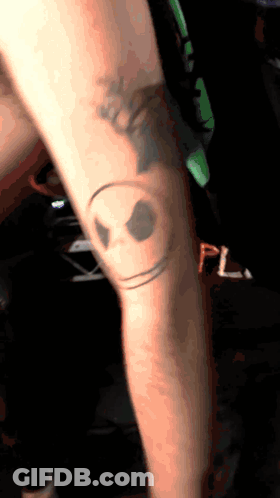 Person With Smiley Face Knee Tattoo GIF