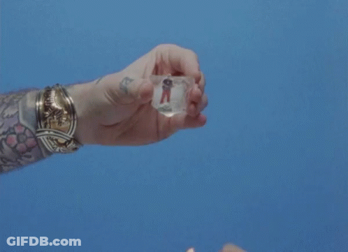 Person With Tattoo Holding Lighter And Ice GIF