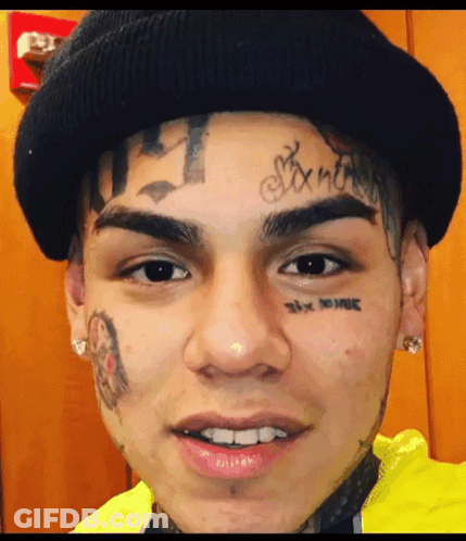 Person With Tattoo Saying Six Nine GIF