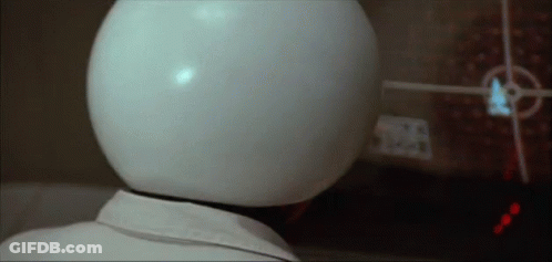 Person With White Helmet Looking At Screen GIF