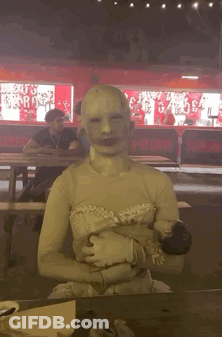 Person With White Mask Sitting At Table GIF