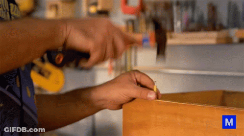Person Working On Wood With Letter M GIF