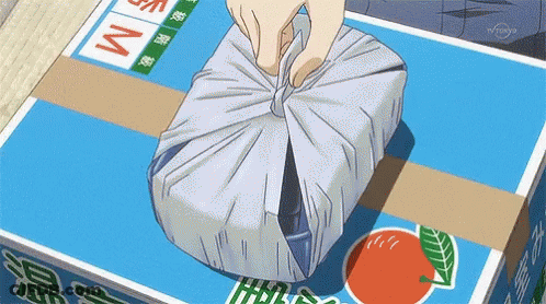 Person Wrapping Package In Blue Box Saying M GIF