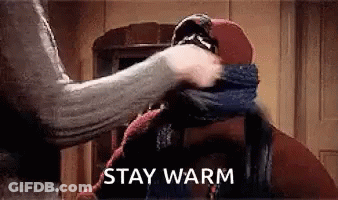 Person Wrapping Scarf Around Head Saying Stay Warm GIF