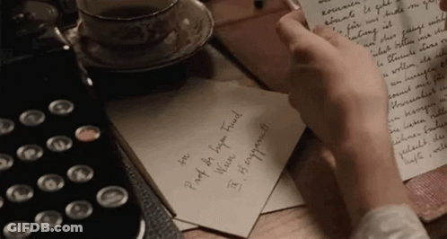 Person Writing On Paper With Coffee And Typewriter GIF