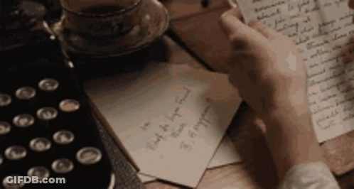 Person Writing On Paper With Coffee GIF
