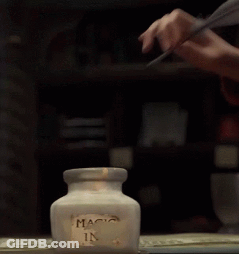 Person Writing With Feather In Magic Ink Jar GIF