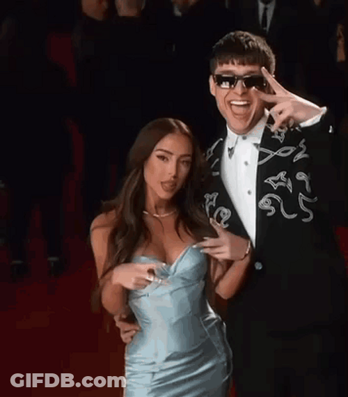 Peso Pluma And Nicki Nicole Posing On Camera GIF