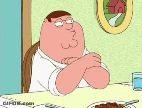 Peter Griffin Is Sitting At A Table With His Arms Crossed GIF