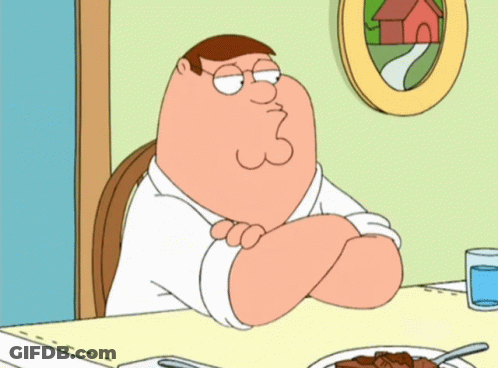 Peter Griffin Sits At A Table With His Arms Crossed GIF