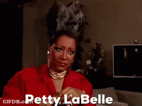 Petty La Belle In Red Jacket And Gold Necklace GIF