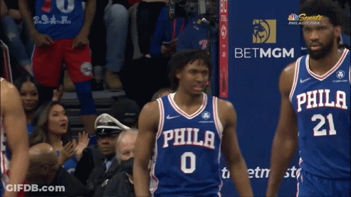 Philadelphia Basketball Players In Front Of BetMGM Sign GIF