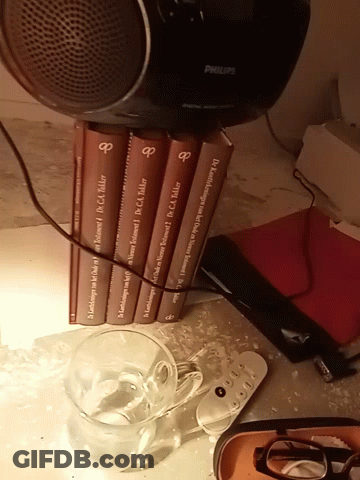Philips Speaker Next To Stack Of Books GIF