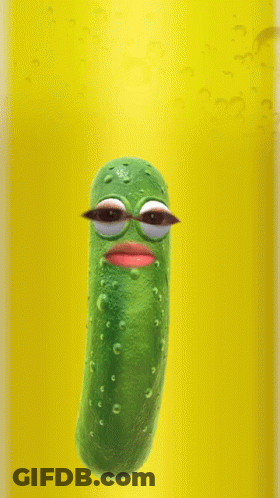 Pickle With Big Eyes Floating In Yellow Liquid GIF