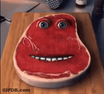 Piece Of Meat With Face On Cutting Board GIF