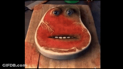 Piece Of Meat With Face On Cutting Board GIF