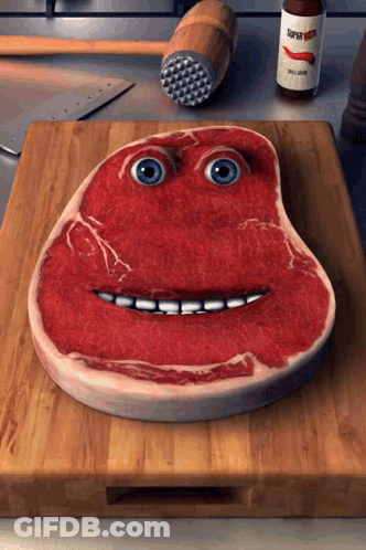 Piece Of Meat With Face On Cutting Board GIF