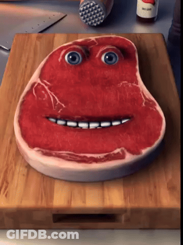 Piece Of Meat With Face On Cutting Board GIF