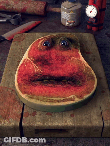 Piece Of Meat With Face On Wooden Cutting Board GIF